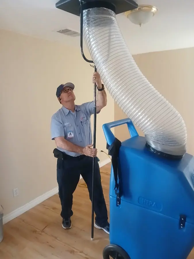 Furnace Tune-Up technician using HEPA equipment in Plum